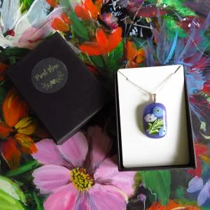 fused glass pendant with for get me not design purple glass